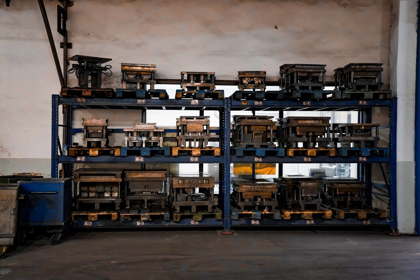 Industrial casting molds arranged on racks, representative photo