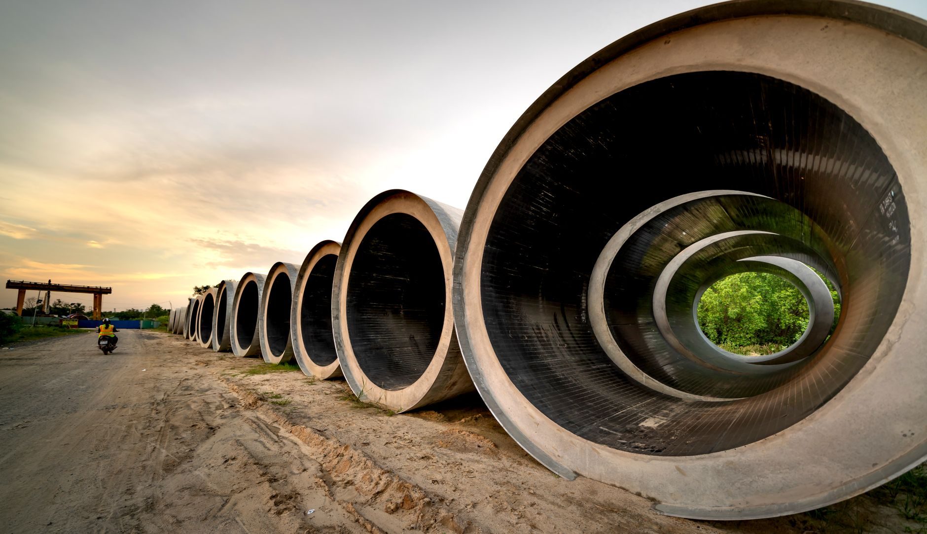 Large precast concrete sections lined up at a jobsite at sunset, representative photo