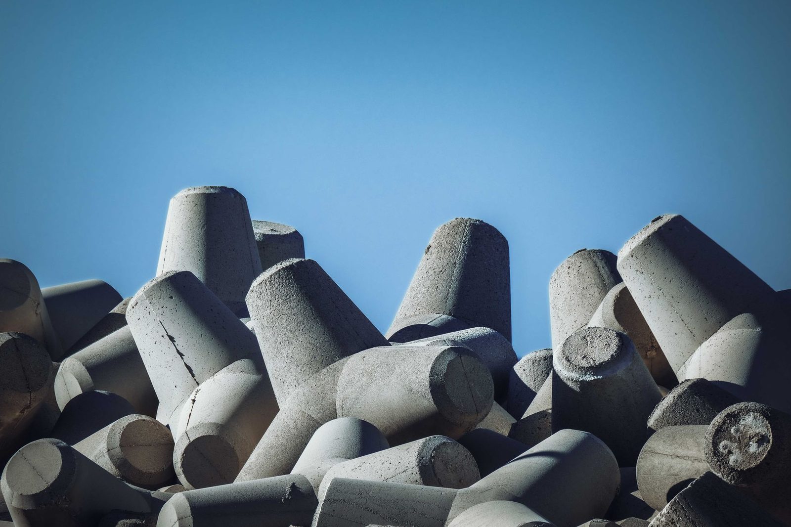 Heavy sculptural precast concrete blocks against a blue sky, representative photo