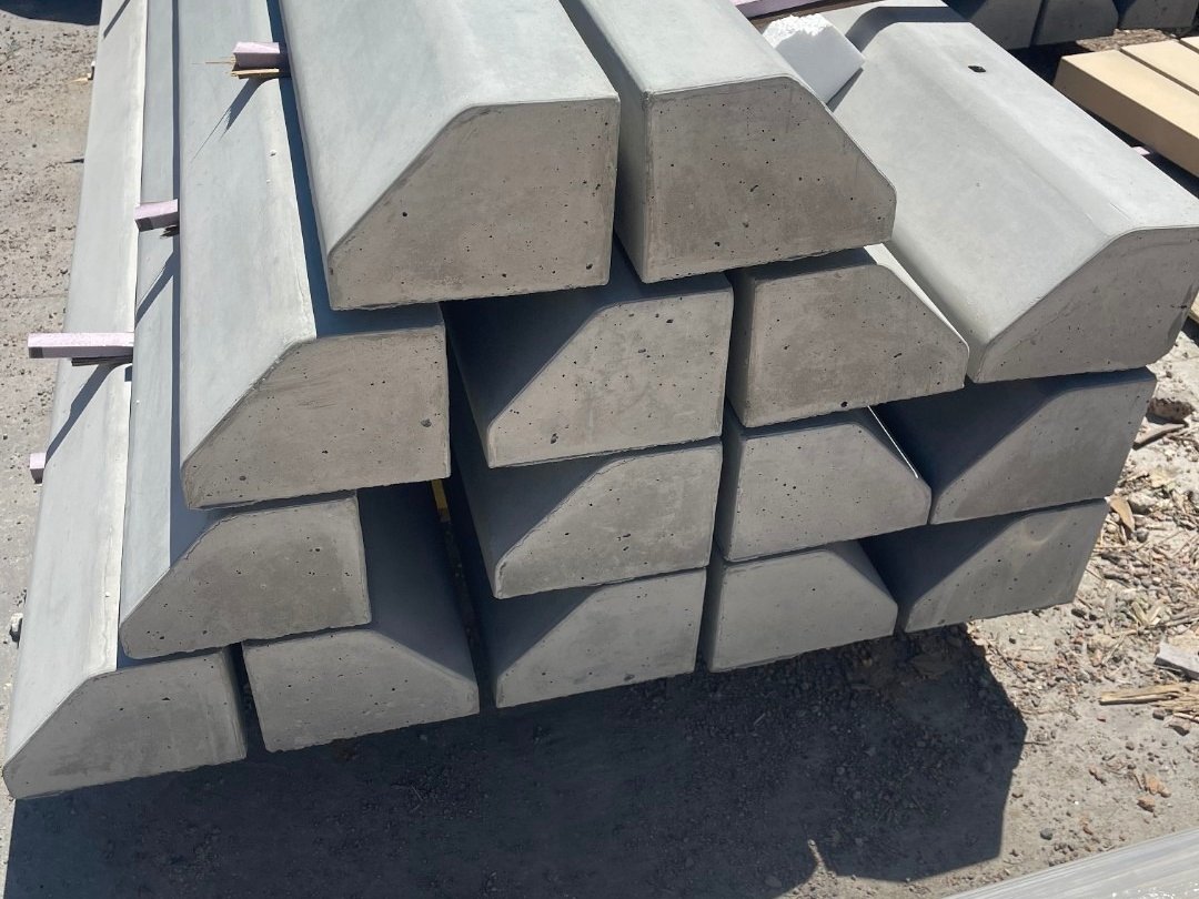 Freshly cast precast concrete parking curbs stacked in the Del Rio yard in Brighton, Colorado